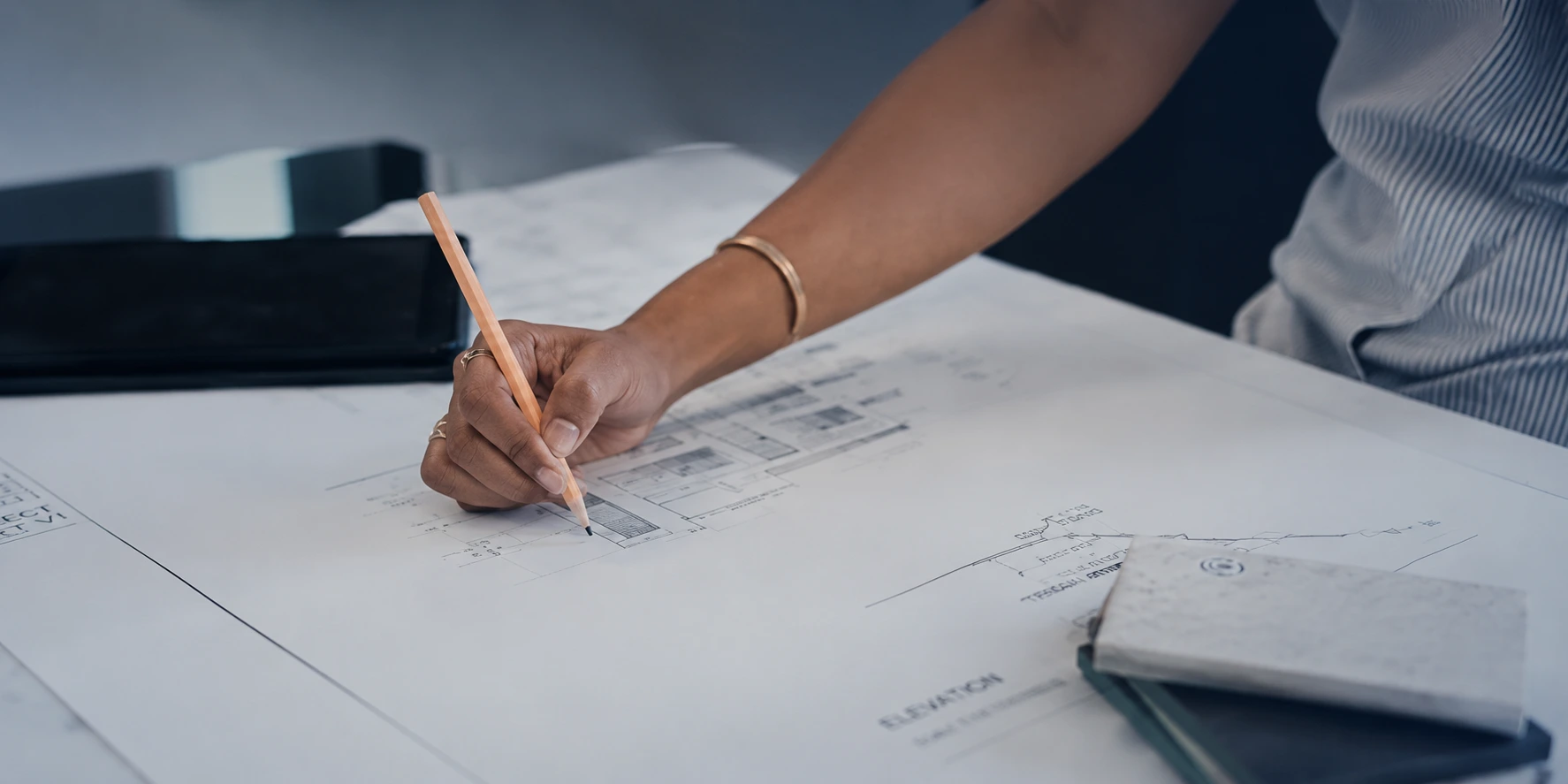 Hands sketching architectural plans